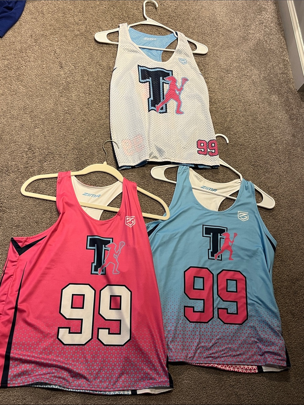 2 lacrosse jerseys with matching practice pinnie